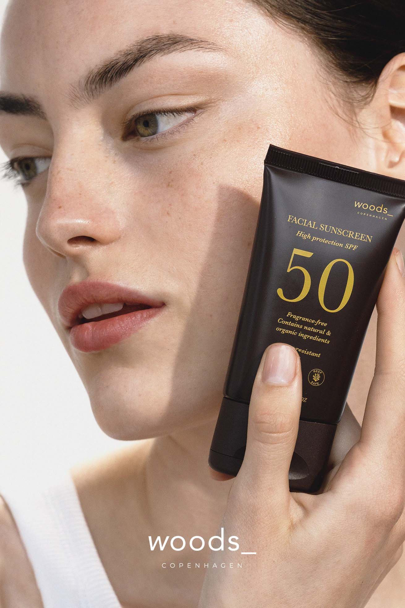 Bottle of Facial Sunscreen SPF50 by Hortus, featuring a white label with green text, against a soft background.